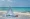 White tent on beach with picnic basket