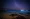 Bioluminescent bay at night under stary night